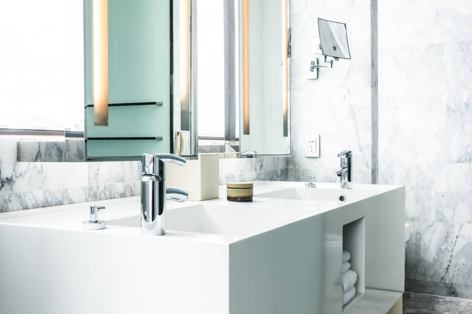 Modern white double-sink bathroom vanity with chrome faucets