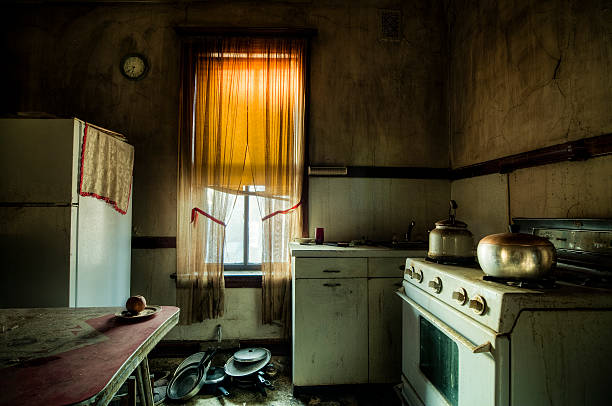 Old kitchen with peeling, damp-stained walls showing the effects of humidity