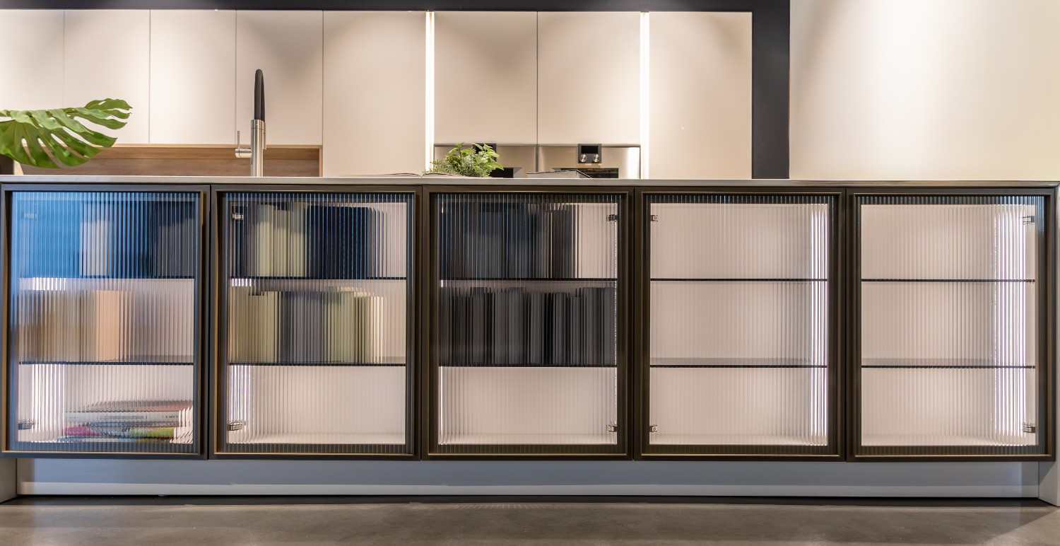 Fluted glass-front cabinets with interior lighting